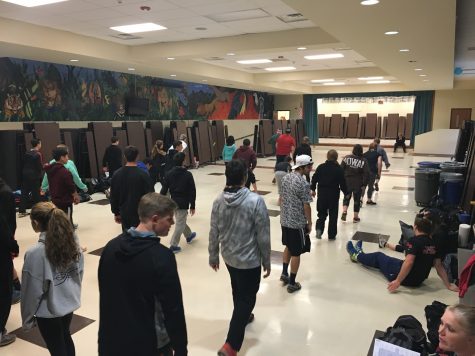 On days where it is difficult to practice outside due to poor weather conditions, the coaches take practice indoors, where the athletes warm up in the cafeteria.