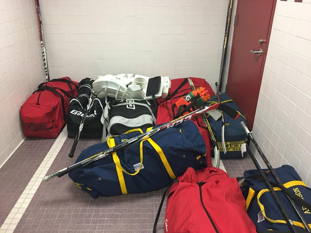 After being dragged through the school, hockey bags are stored in the locker room. An increase of enforcement of a safety policy prohibiting the use of the Sports' Lobby door has angered many students, specifically hockey players.