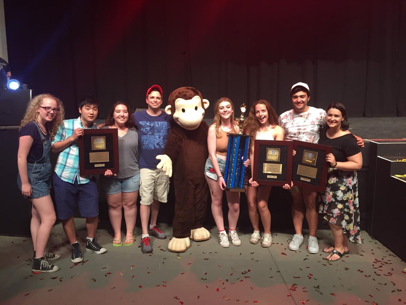 Representatives from the Chamber, Women's, and Concert Choirs pose as they accept their awards along with their directors, Carl Helder and Anna Lilikas. All three choirs were ranked in the gold division at the Worldstrides choral competition at Universal Studios in Orlando, Florida.