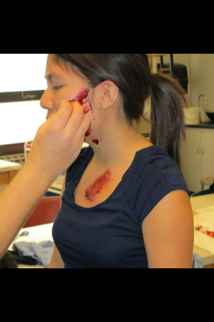 The injuries may be fake, but the school security drill tested Norwoods emergency response system.  Glen Rocks own Marleigh Felsenstein took part in the event as a member of a local improv group.  Here, a cast member is prepared for the security drill with realistic costume make-up.