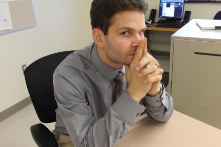 Michael Corby shows off his dashing gray shirt for the camera. 