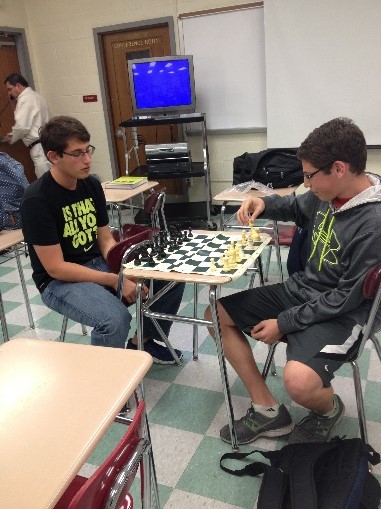 President Jonathan Kane (’15) starts to play a chess game against his teammate and brother Adam Kane (‘16).