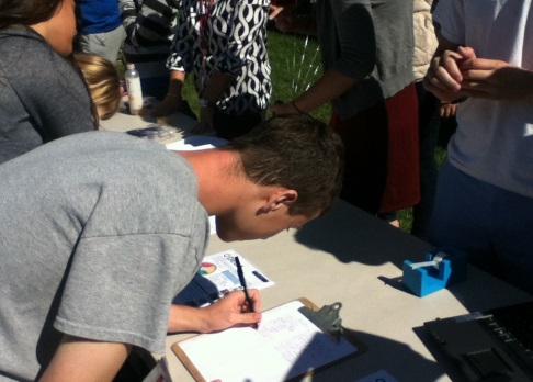 Ryan Stolz, Junior, adding his name to the popular DECA signup sheet. DECA helps the students of Glen Rock with their knowledge of business. 