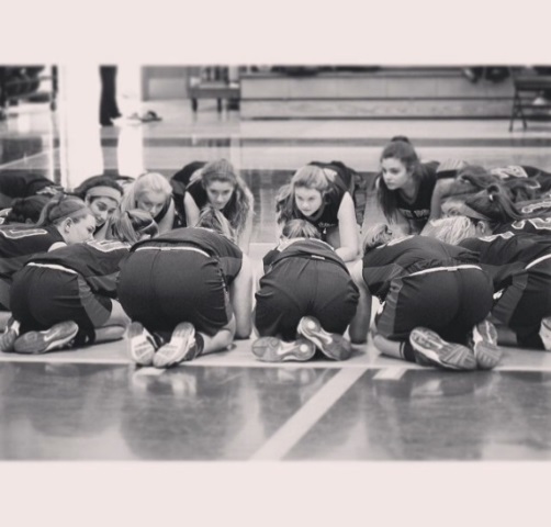 The girls talk strategy and encourage each other before every game.