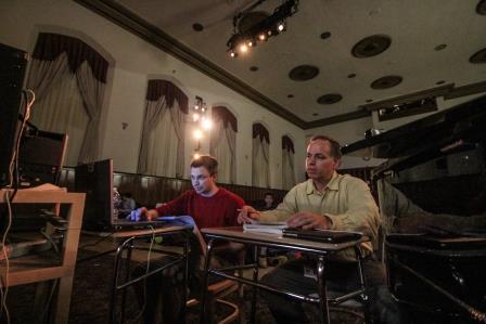 Mr. Helder (vocal music director) and Mr. Kurland (band director) working together and studying the music of the play. 