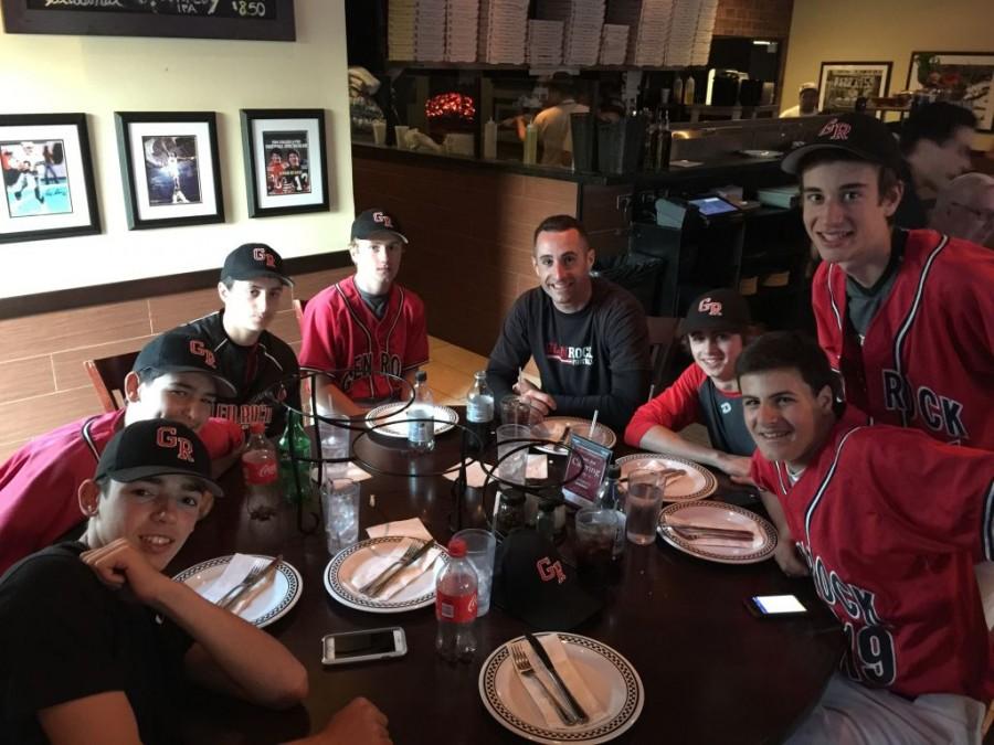 Freshman baseball coach, Dan Polles, sitting with members of the team at Anthony's Coal Fired Pizza.