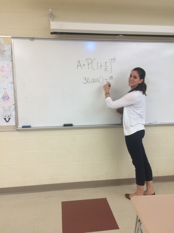 Ms. Fanelli commands the whiteboard while she teaches the class a new formula.
