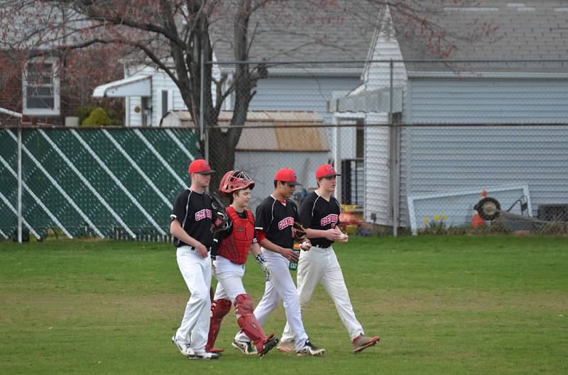 Palmeri discusses pitching with senior pitchers Greg Warner, Connor Browne, and junior catcher John Scandale.