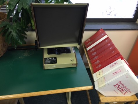 The microfilm viewer machine that takes in the film and displays the newspaper for the reader to read.