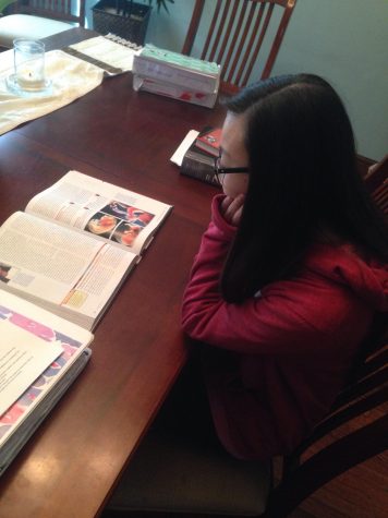 Roddy sits at her dining room table, working on her Biology homework, the class she dedicates the most time to.