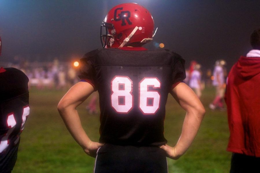 Michael Quinn watches over his sixth grade football team from the sidelines of Faber Field in 2011.