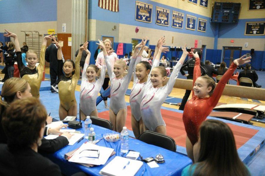 Sophia and teammates on the floor of Atlantic City Convention Center at a state competition in front of the judges in 2010. 