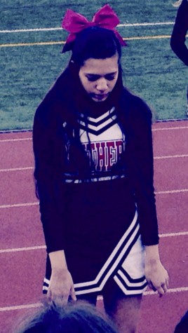 Christina cheering for the JV team during one of the coldest football games 