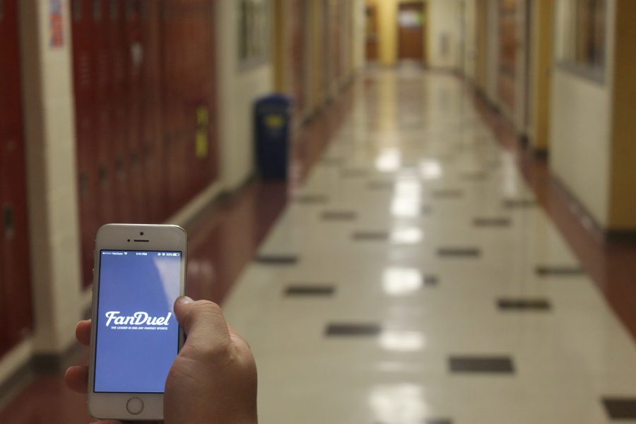 A student at Glen Rock High School uses his iPhone to access the FanDuel app.