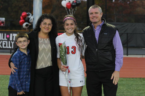 Julia on Senior Day with her parents, Lucy and Peter and younger brother.