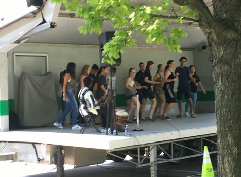 A group of students performing a dance at the 2016 Teen Arts Festival to the beat of traditional drums.