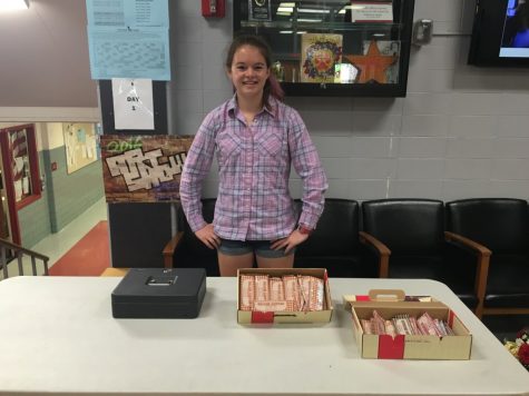 Alex Walters (18') sells chocolate bars in the Hamilton Lobby.