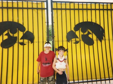 Weiss is posing in front of the football team's practice facility with Xavier, a friend he made at the Ronald McDonald House.