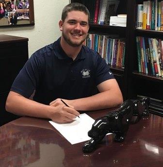 Mike O'Hagan at signing day wearing a Moravian College polo shirt.