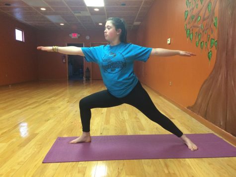 Struble doing the Warrior II pose at Naturally Yoga.