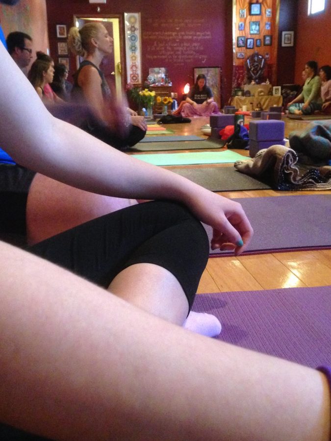 Struble teaching a yoga class at Naturally Yoga. 