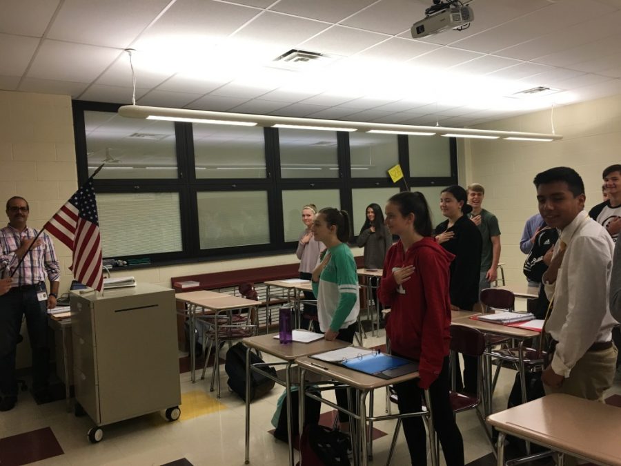 Students stand for the Pledge of Allegiance during morning announcements. Several students have chosen to sit for the Pledge to raise awareness about the racial discrimination that is happening in the United States. 