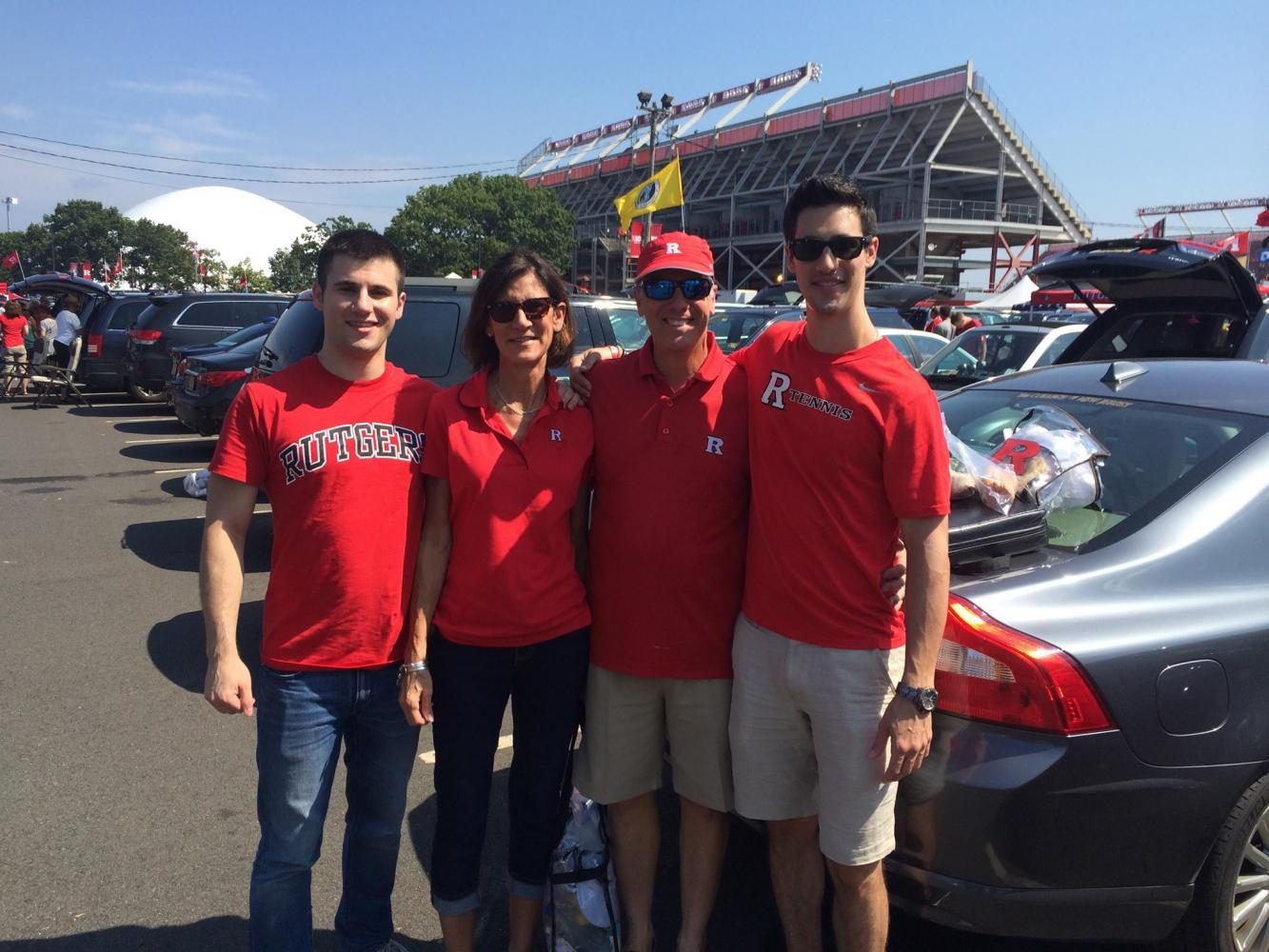 Brett, Judith, Scott, and Scott Sr. pose for a photograph at a Rutgers football game. The photo was taken a few years before Scotts mother passed away from cancer, sparking a journey -- both inner and outer -- that would change his future. 