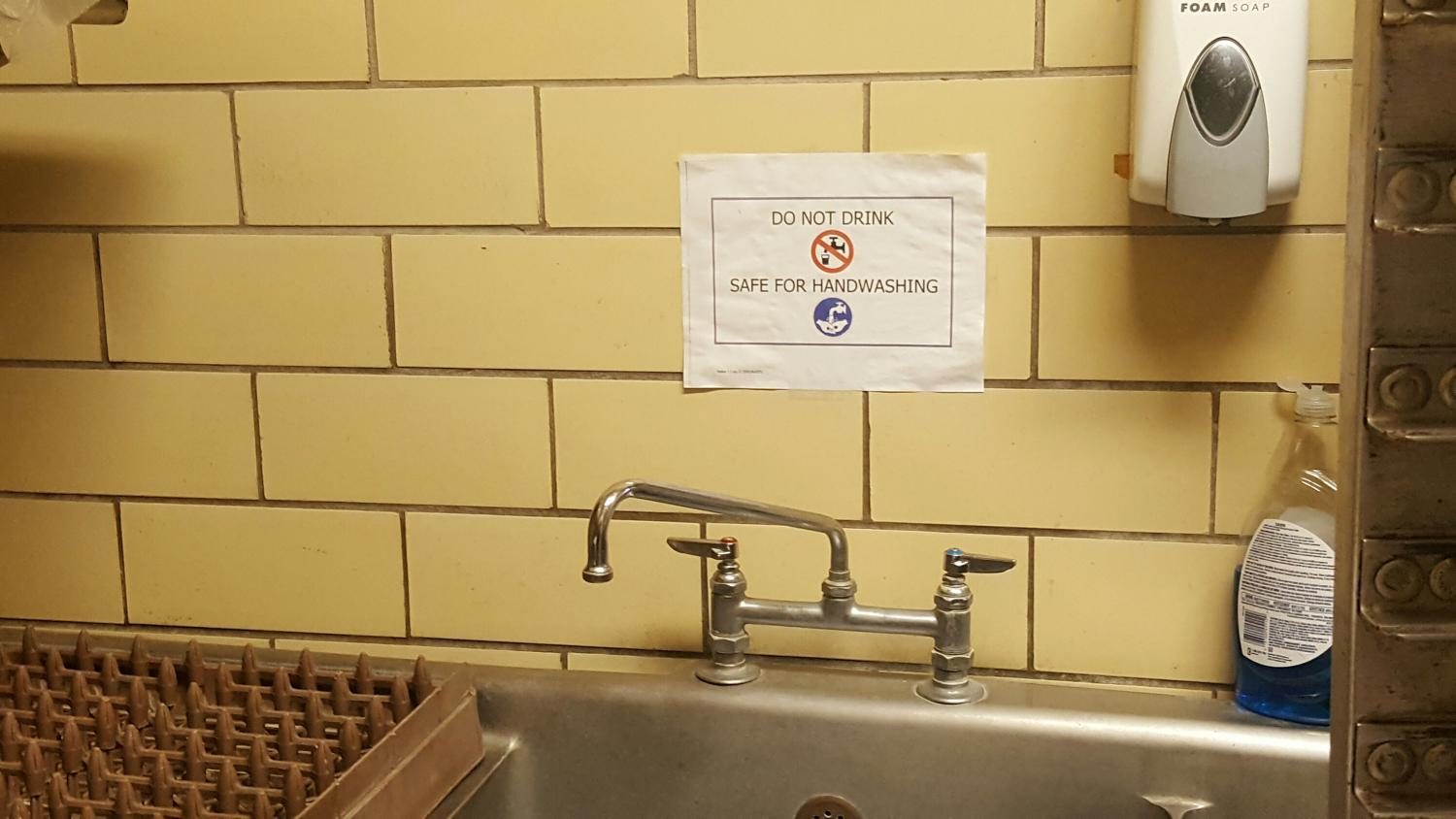 Testing 194 samples in the district, officials discover that 25 water outlets exceeded the legal limit of 15 ug/l in parts per billion. The sink in cafeteria cookie room is one such spigot, now advising that the water is not for consumption. 