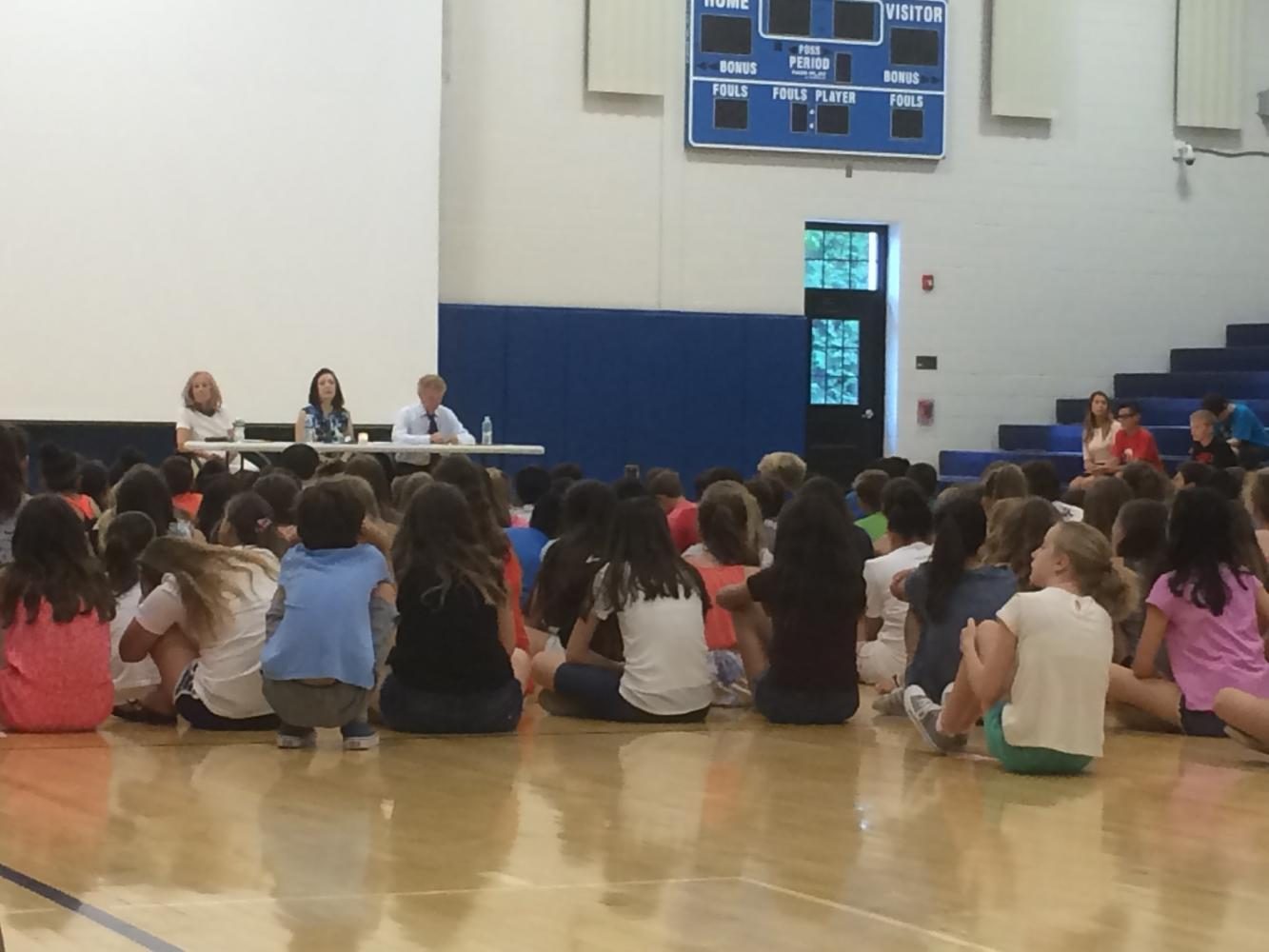 From left to right; Vera Chapman, Barbara Wind; Michael Zeiger; Students watch survivors discuss the Holocaust in the George Washington Middle School gym. Moments before, a candle was lit to remember victims of the Holocaust.