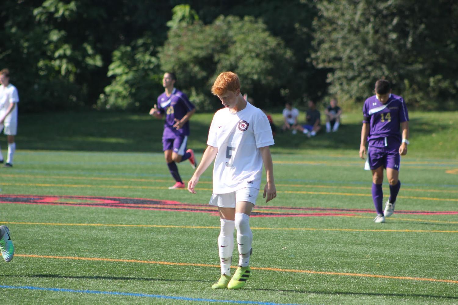Ben Zakowski walks down the field as the team prepares for play to resume.
