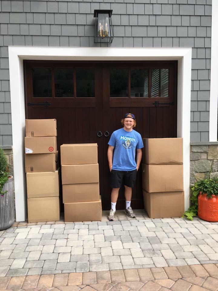 Photo Credit: Max Lindley
Max Lindley stands beside some of many contributed boxes. The packages were mailed to a hurricane shelter in Houston.