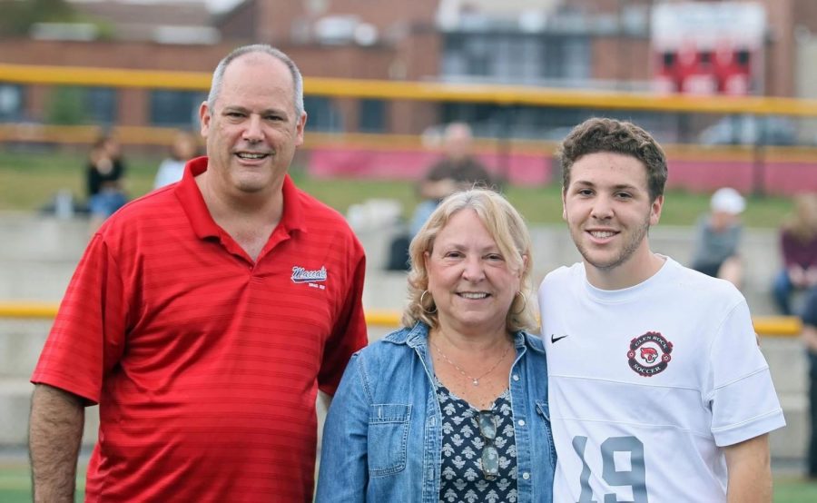 Senior Josh Quiat poses with his mother and father on Senior Day, Saturday, Oct. 14. 