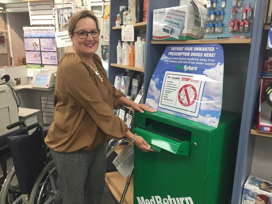 Michelle Torpey opens the new prescription drug recycle box in Rock Ridge Pharmacy. She took initiative to help people dispose of addictive opioid drugs in Glen Rock. She raised money for this box with gofundme.com.