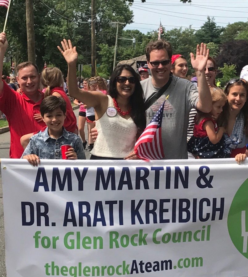 The Kreibichs wave to residents as they take part in the July 4th parade.