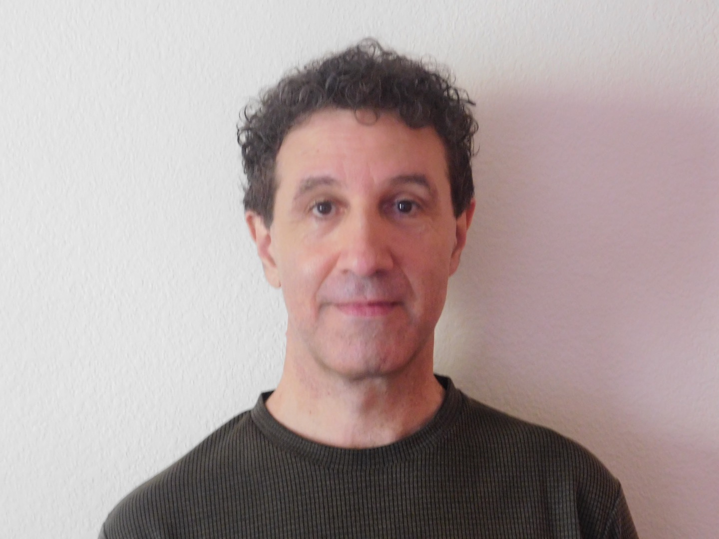 Mark poses for an ID card for one of his other business ventures. He does many side businesses including being a musician, and credit card processing.