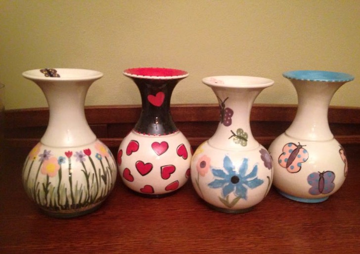 Barbra lines up four spring-themed vases for a photo. Barbra frequently customizes her pottery depending on the season, and takes inspiration from nature in almost everything.