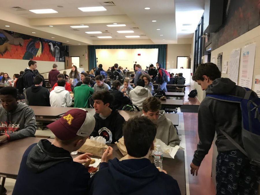 Students enjoy lunch as they sit and talk with their friends in the cafeteria.
