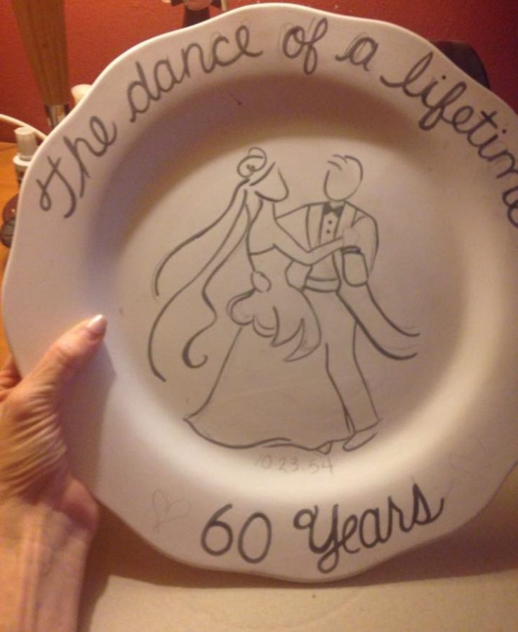 Before firing it in her kiln, Barbra sketches an anniversary plate for a customer. Typically, Barbra uses pre-fired ceramics, known as bisqueware, when making requested pieces for customers.