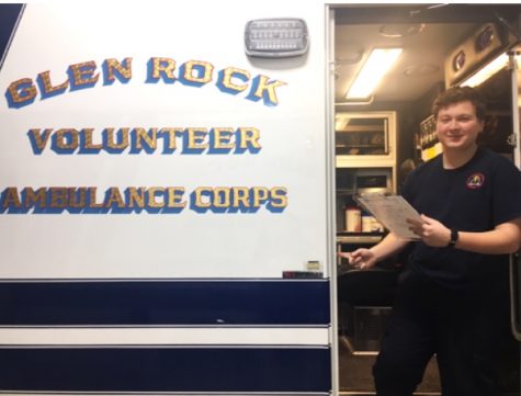 Junior Andrew Bober stands in the doorway of one of Glen Rock ambulances. Bober became
an EMT in August 2017.