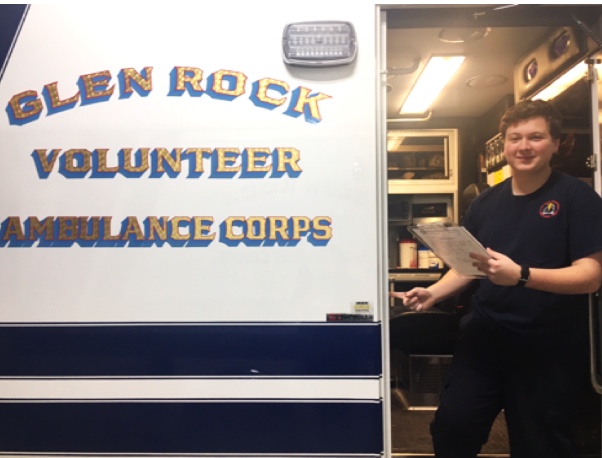 Junior Andrew Bober stands in the doorway of one of Glen Rock ambulances.  Bober became 
an EMT in August 2017.
