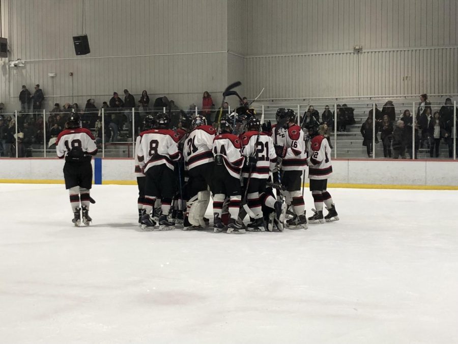 The 2017-2018 boys ice hockey team celebrates after defeating Monville, 7-0. With a new coach and a talented roster, players are optimistic for the season ahead. 