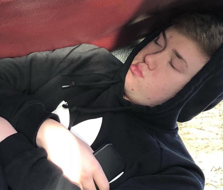 Sophomore Jack Lyon takes a nap during a bus ride home after a basketball game to cap off a long day of school.  