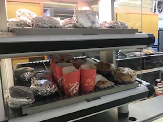 This is a picture of popular lunch selections in the cafeteria right now. This includes a selection of wrapped burgers, sandwiches, wraps, chicken nuggets and french fries.