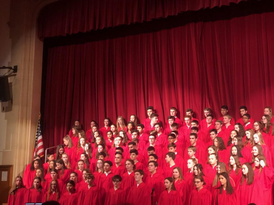 The concert choir cheerfully performing You Will Be Found.