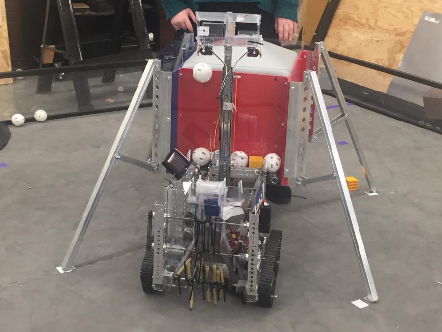 The teams robot retrieves Wiffle balls on a FTC game board. In order to do so, it follows a script of code written by the team. The programming is being fed to the robot through a phone strapped to the machine. 