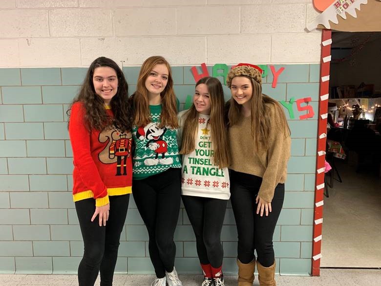 Senior Theatre Company executive board members (left to right) Sofia Nolfo, Madelyn Willoughby, Sofia Karras, and Caroline Torpey snap a picture at the Theatre Company, LEAP, and Alliance holiday party. They loved all of the activities and games and had a great time with members of other clubs!