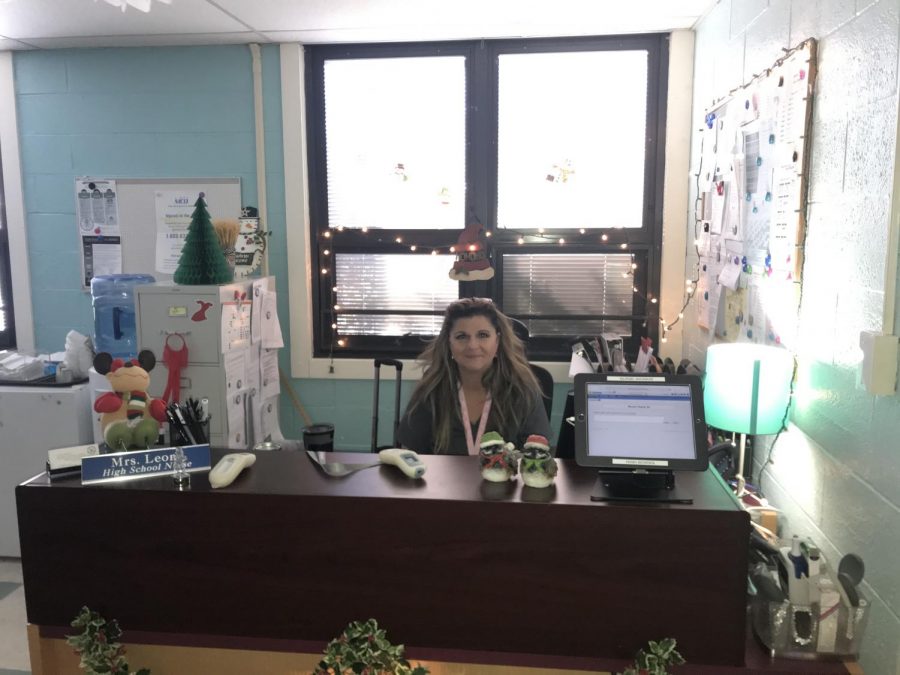 High school nurse Ms. Robin Leone sitting at her desk in the nurse's office.