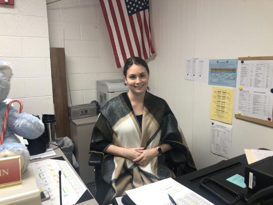 High school Administrative Assistant Rebecca Stadlin works at her desk in the attendance office.