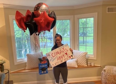Senior Abby Kirsch poses with gifts given by her
