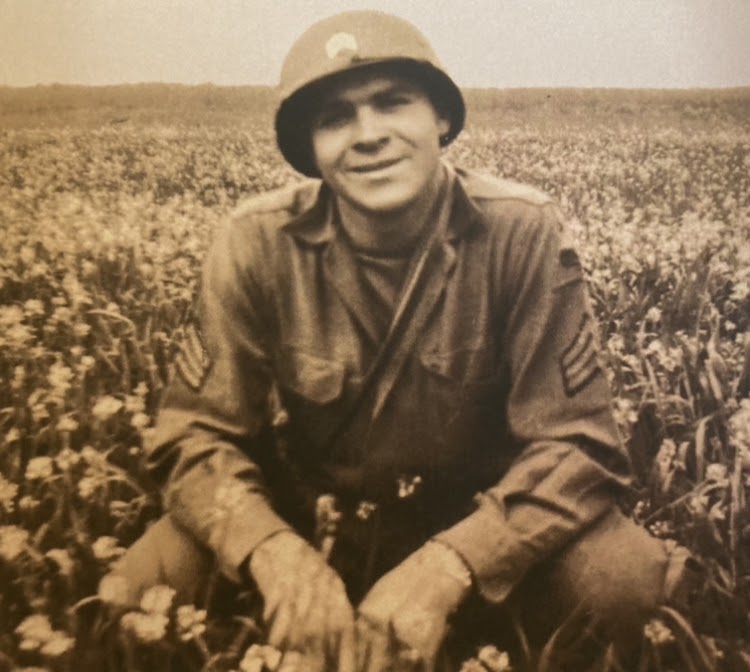 This photograph is of Sgt. Marshall in a field at some point during the war. This image is also the front cover of his book.